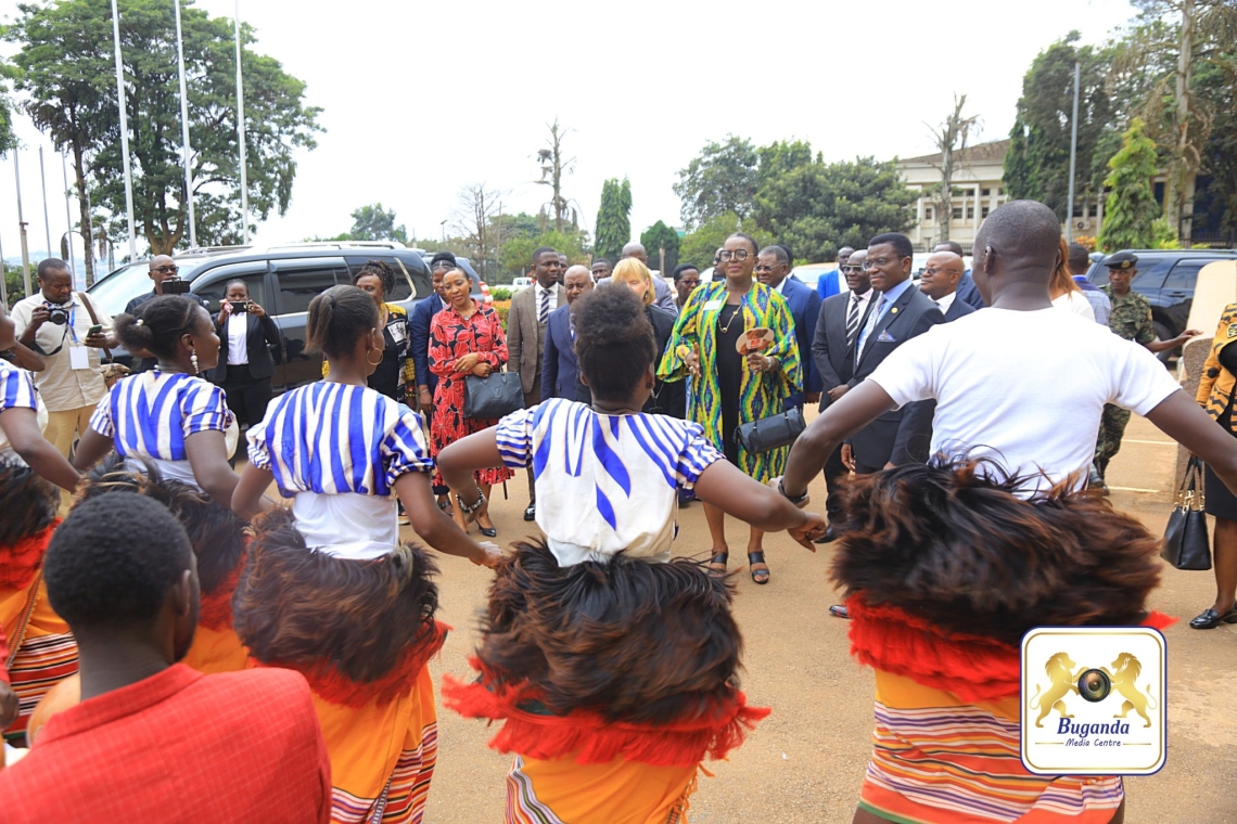 Traditional dancers welcome Stephanie Urchick as Katikkiro Mayiga observes her arrival at Bulange Traditional dancers welcome Stephanie Urchick as Katikkiro Mayiga observes her arrival at Bulange
